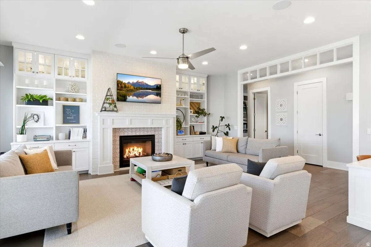 Living area featuring a white brick-surround fireplace with decorative tile work and a classic mantel