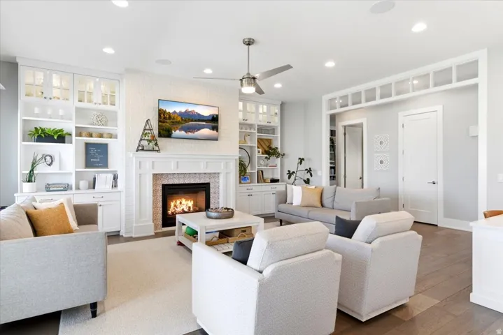 Living area featuring a white brick-surround fireplace with decorative tile work and a classic mantel