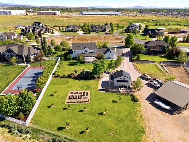 Expansive property featuring a private, raised garden beds, a contemporary barn-style outbuilding, and ample open green space