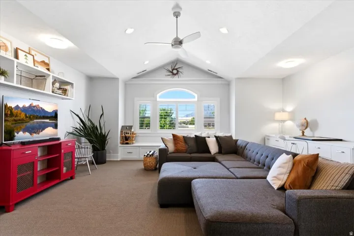 Vaulted ceiling with recessed lighting and a ceiling fan