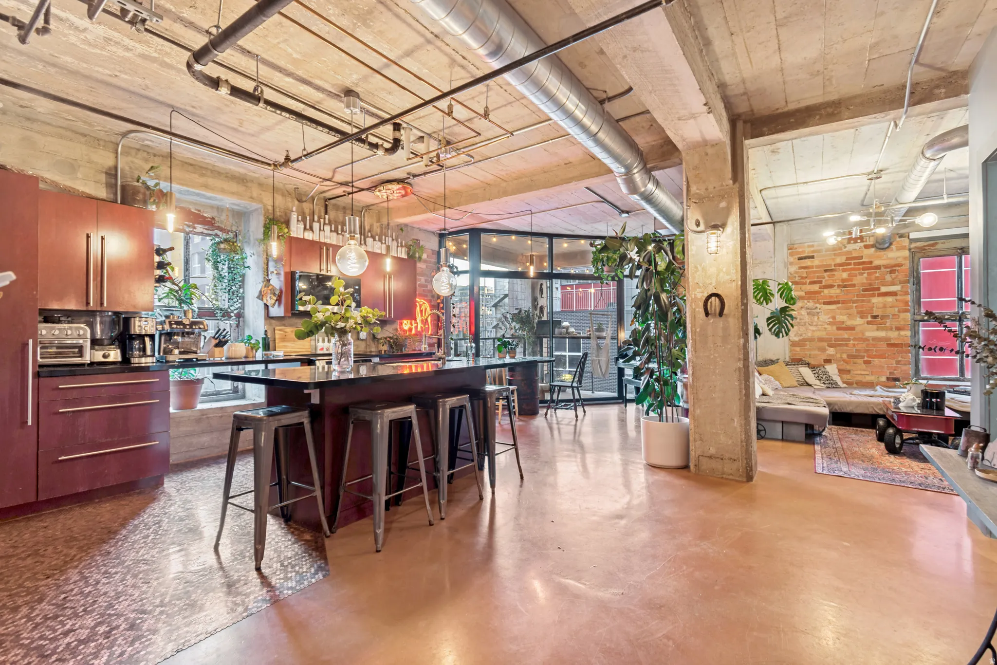 Industrial-style open concept space featuring exposed concrete ceilings and columns