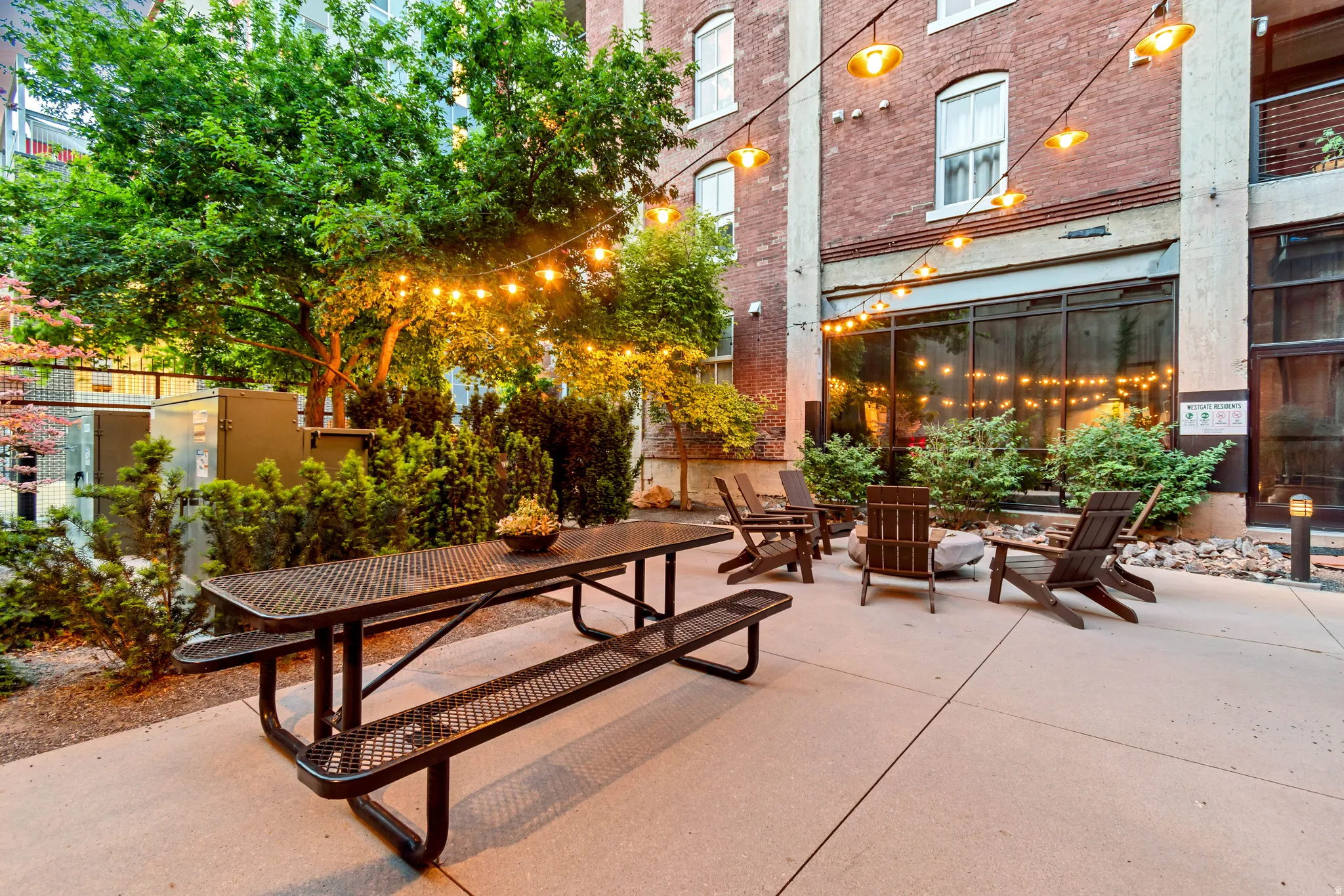 Outdoor patio area with string lighting and concrete paving