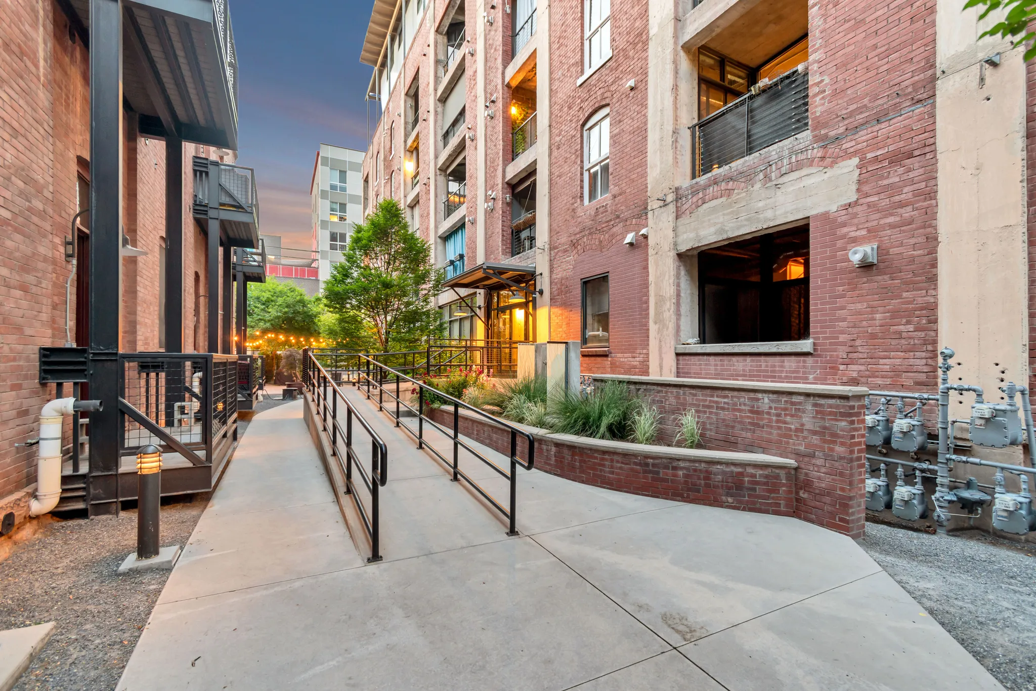 Concrete ramp with black metal railings providing accessibility