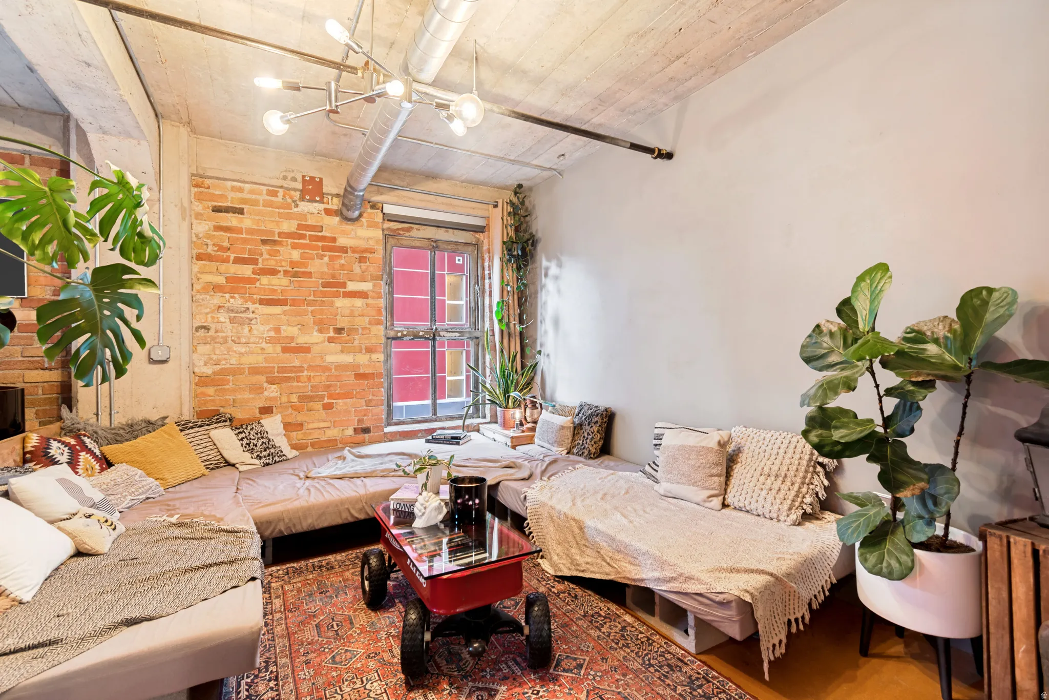 Exposed brick wall with a large industrial-style window