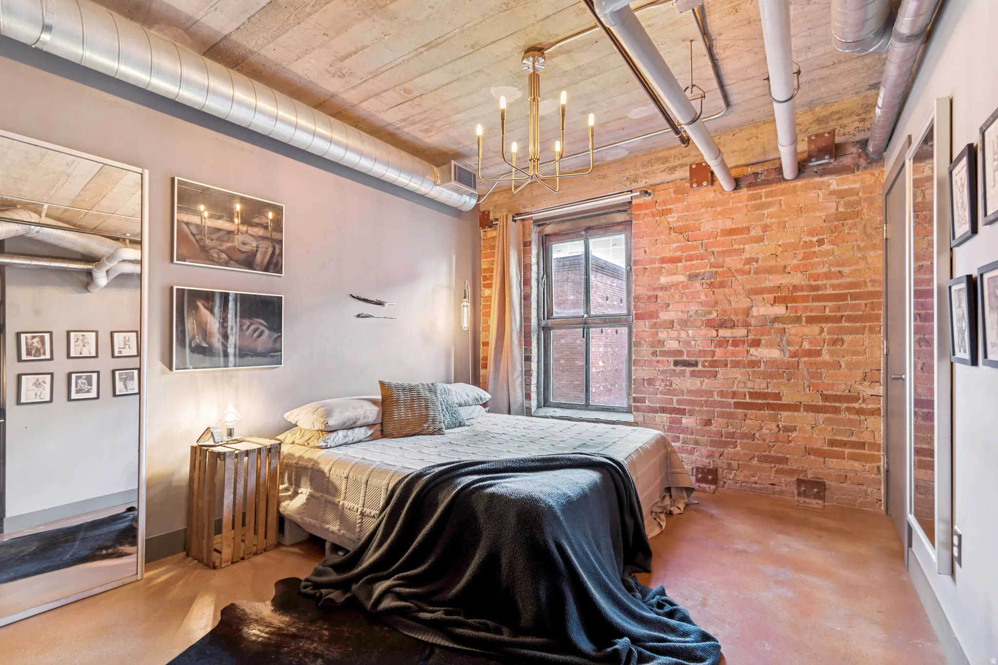 Exposed brick accent wall with a large window