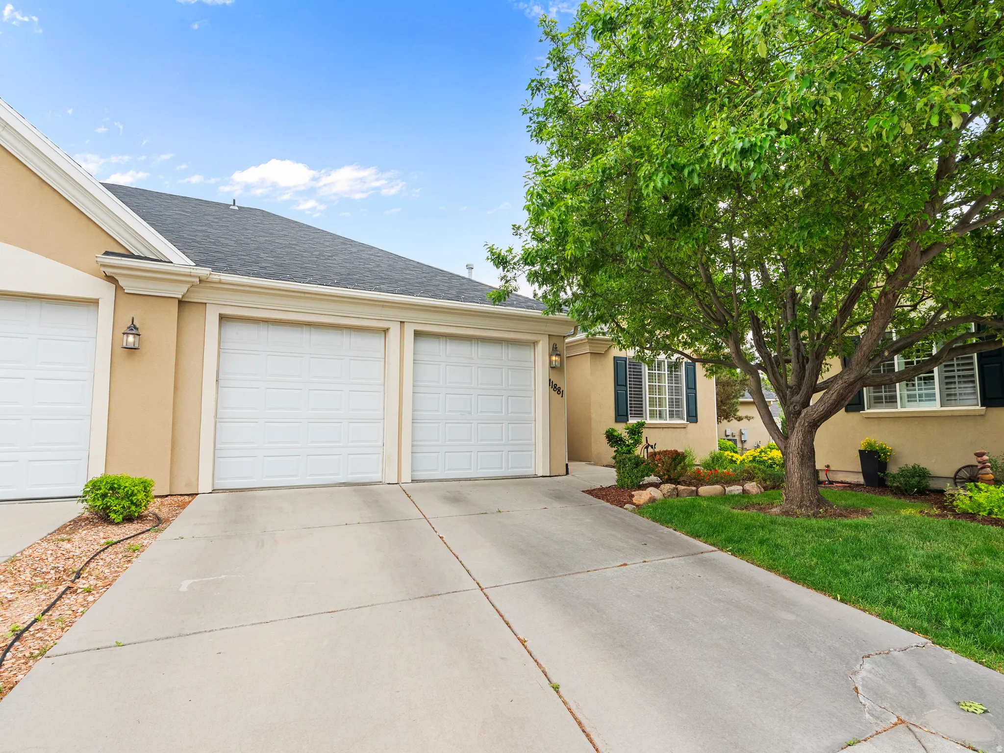 Concrete driveway leading to an attached two-car garage with panel doors