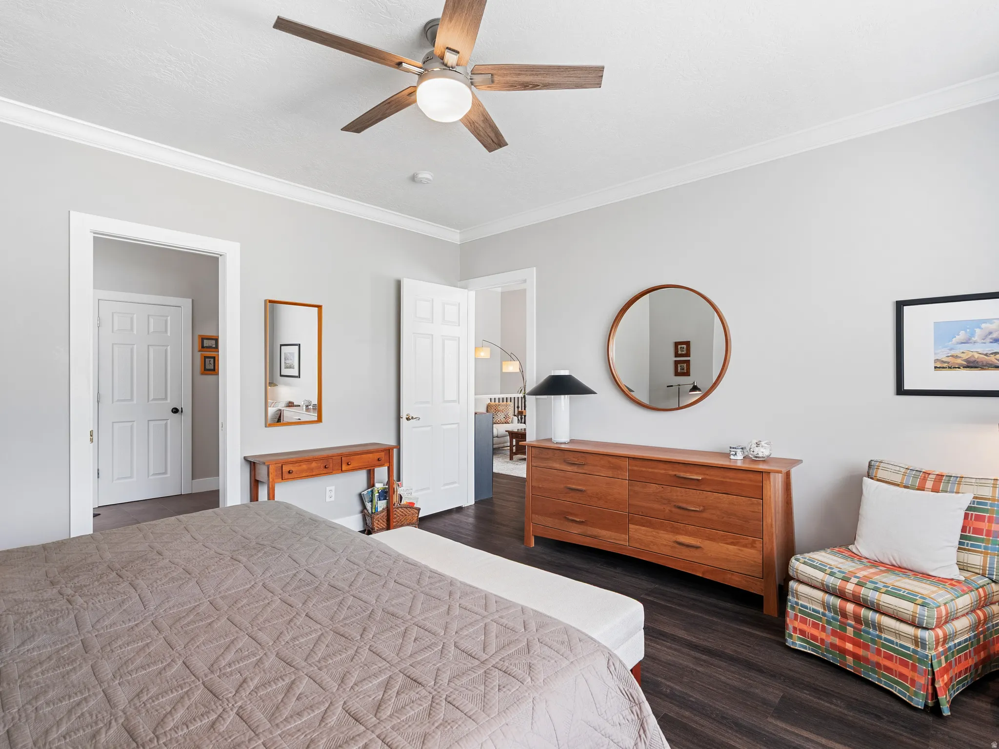 Interior space featuring dark wood-finish flooring, light grey walls, and white crown molding