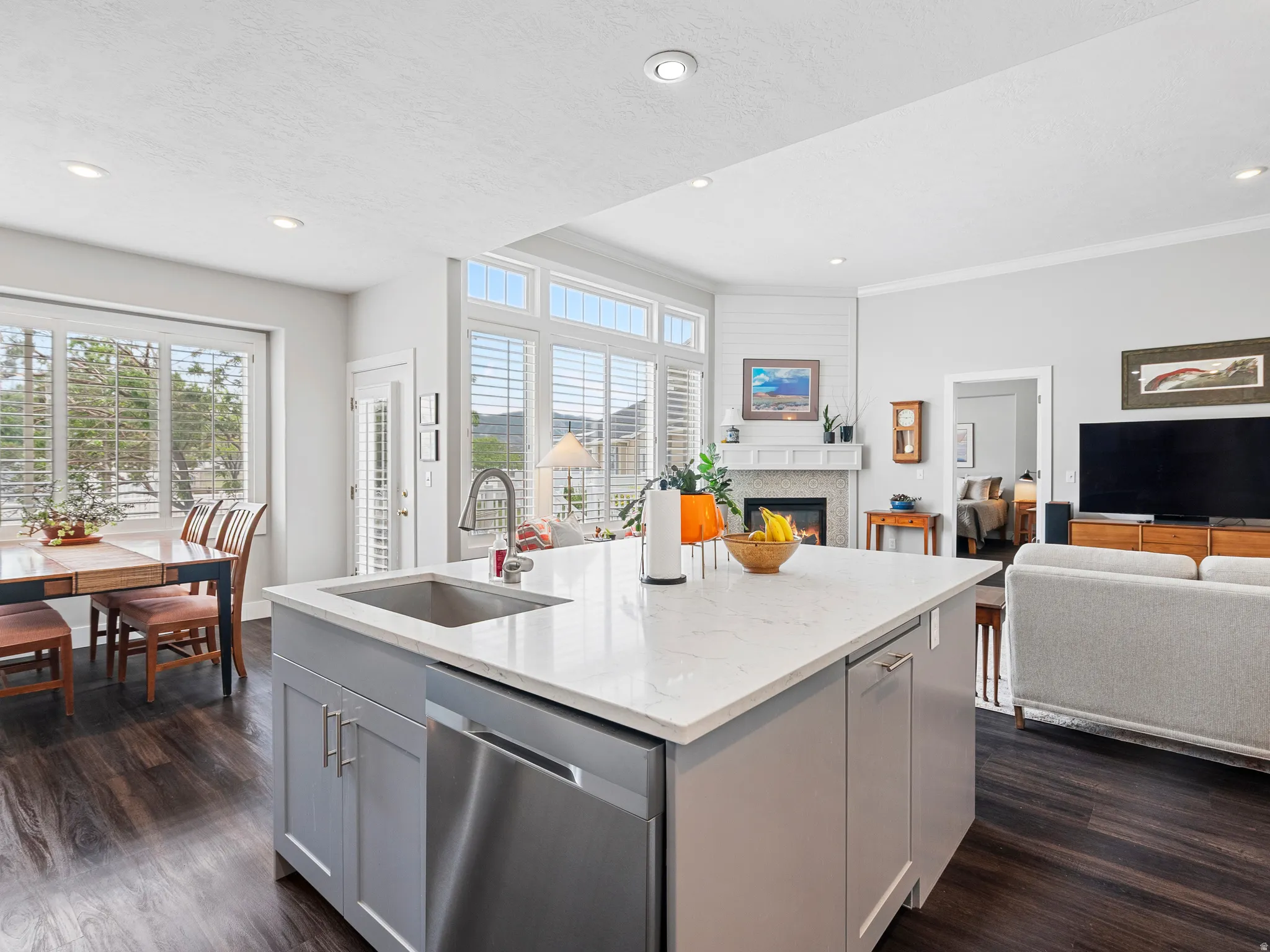 Kitchen island featuring a stainless steel sink and integrated dishwasher