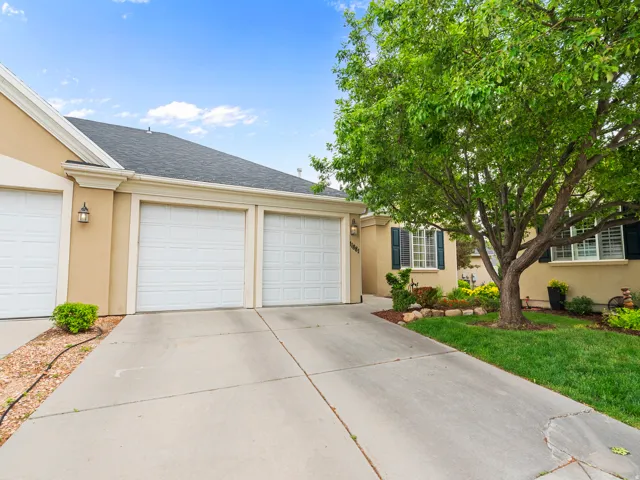 Concrete driveway leading to an attached two-car garage with panel doors