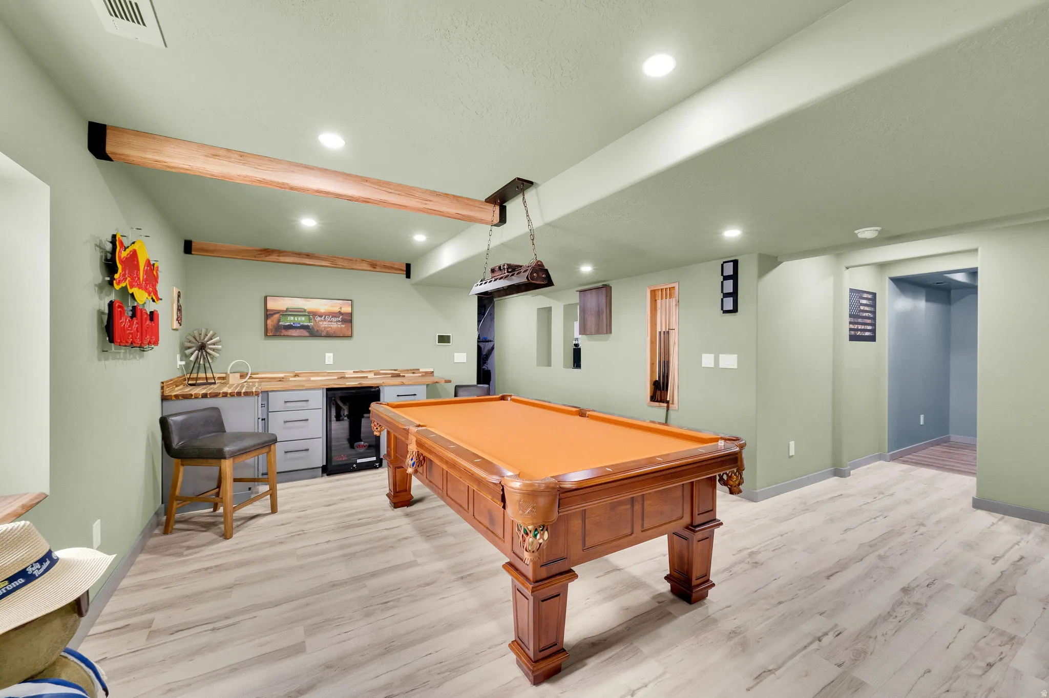 Recreational space featuring a built-in kitchenette with wood-finish countertop, under-counter refrigeration, and recessed lighting