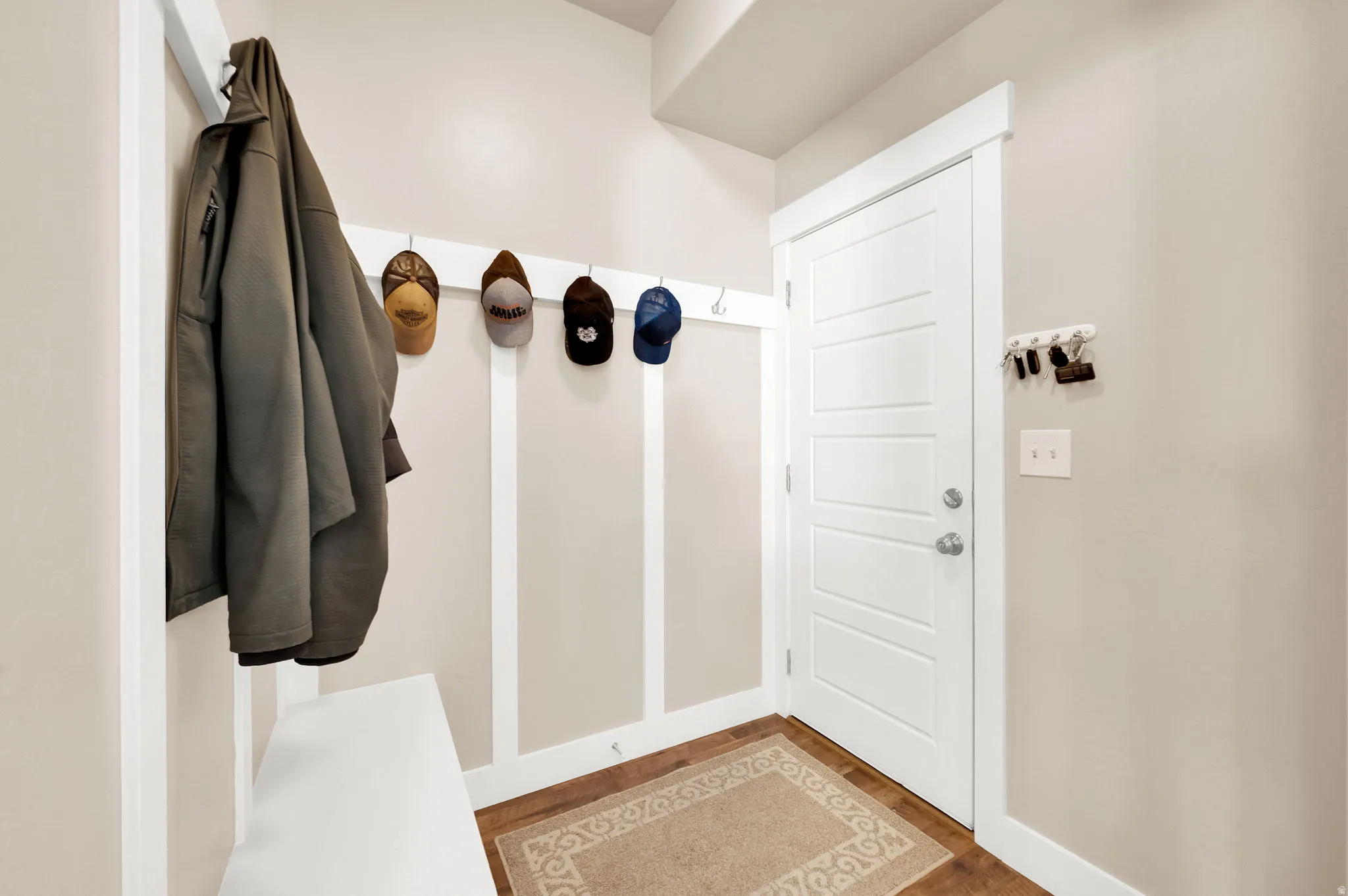 Board-and-batten wall treatment with integrated coat hooks