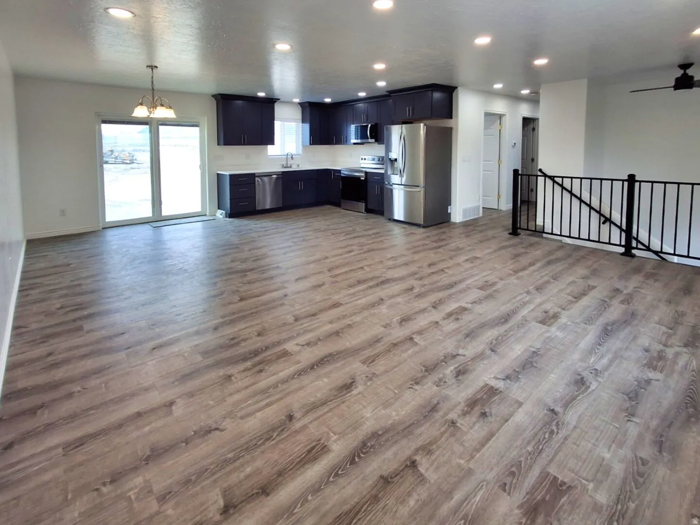 Open-concept living space featuring wood-finish flooring throughout