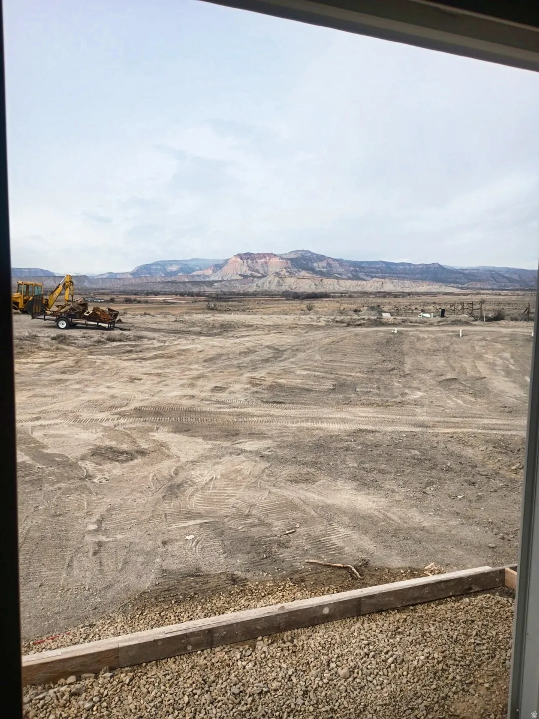 Expansive undeveloped land featuring distant mountainous terrain