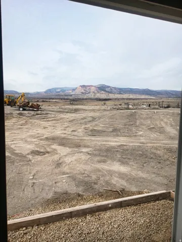 Expansive undeveloped land featuring distant mountainous terrain