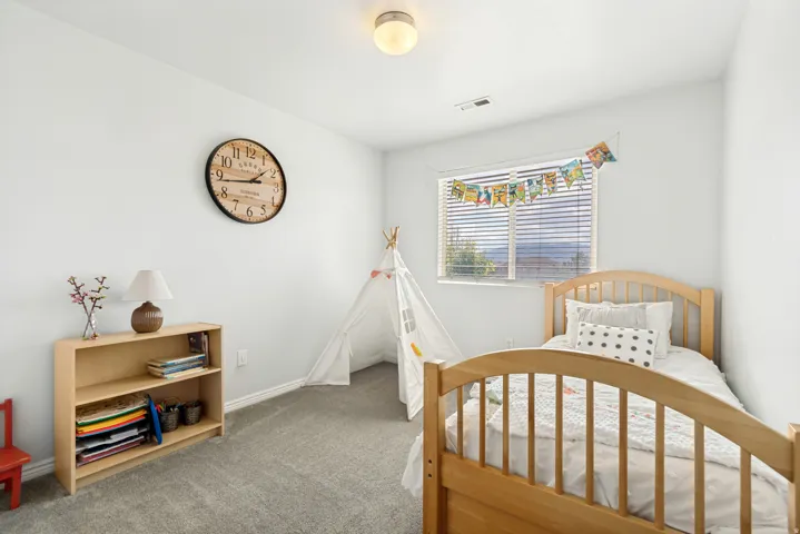 Bright room featuring a window with horizontal blinds, providing ample natural light