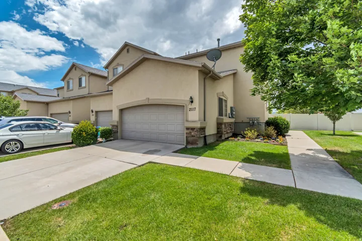 Stucco exterior with stone accents and an attached garage