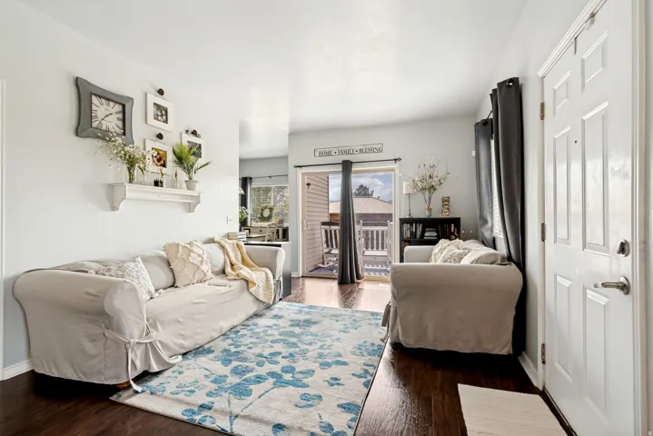 Bright living area featuring wood-finish flooring and a light color palette
