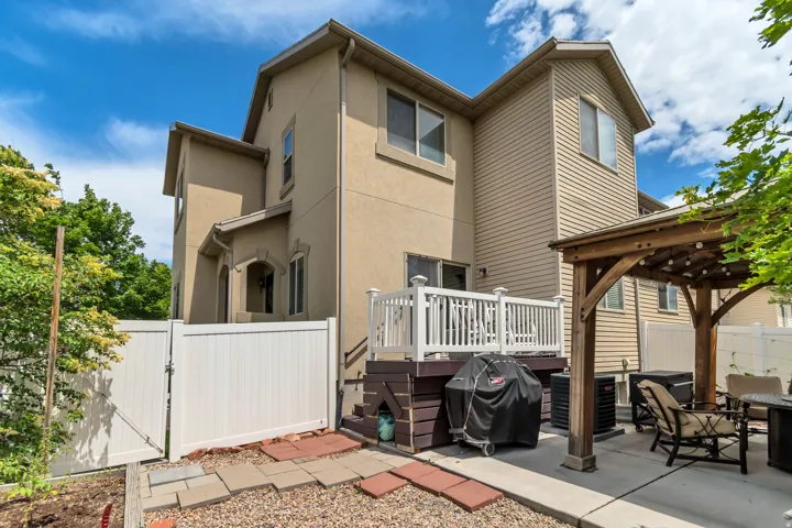 Multi-level exterior featuring tan stucco and horizontal siding