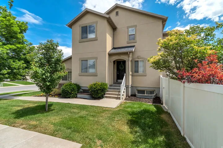 Stucco exterior with a covered entry and white railings