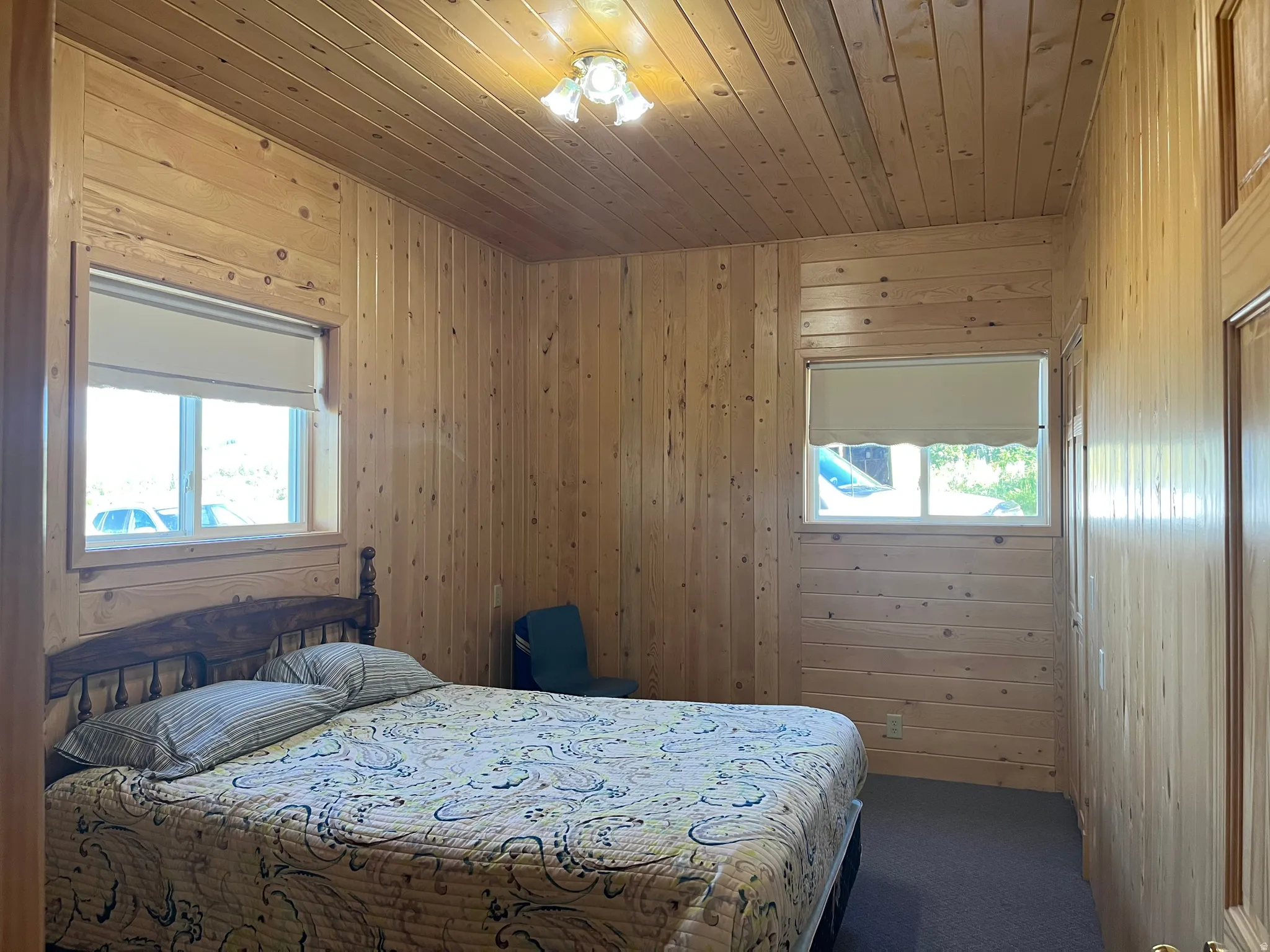 Room featuring extensive wood-paneled walls and ceiling