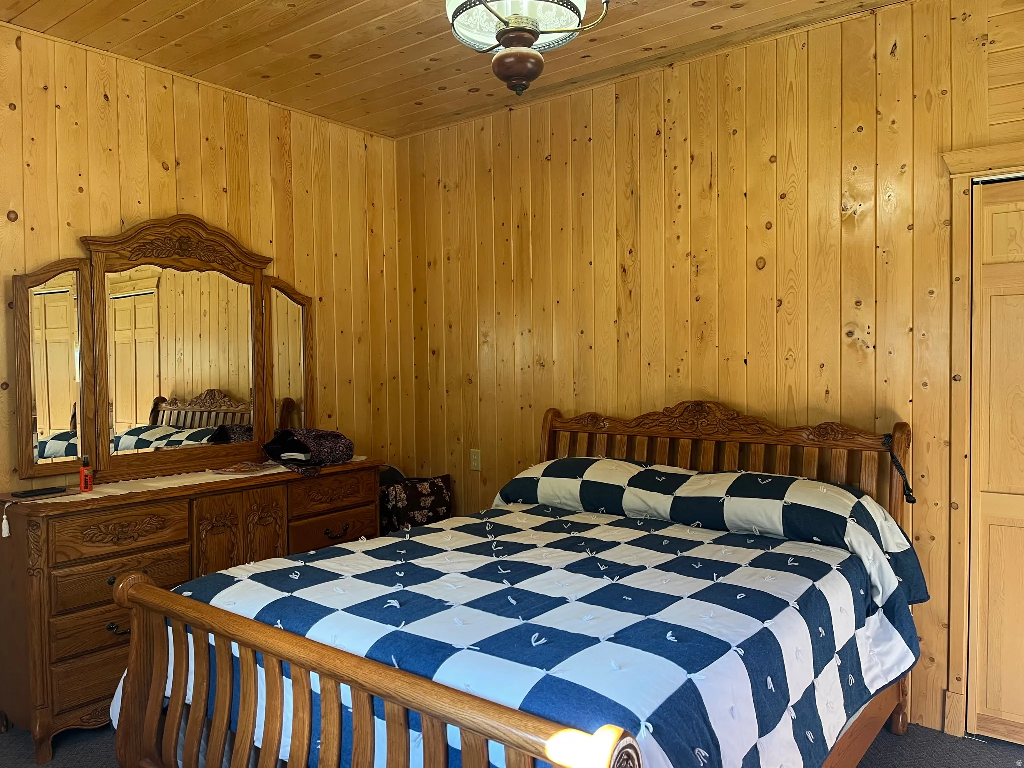 Wood-paneled walls and ceiling in a bedroom space