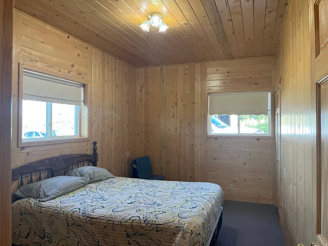 Room featuring extensive wood-paneled walls and ceiling