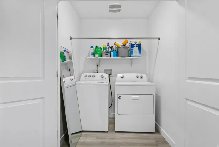 Dedicated laundry area featuring a white top-load washing machine and front-load dryer