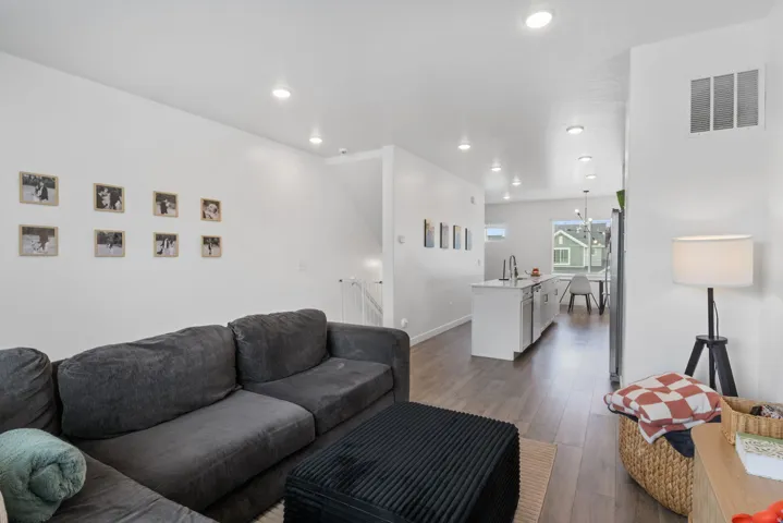 Open concept living area featuring recessed lighting and wood-finish flooring