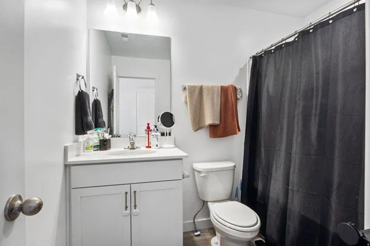 Bathroom featuring a white vanity with a light-colored countertop, an undermount sink, and a brushed nickel faucet