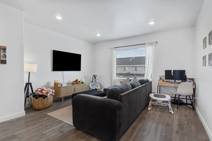 Open-concept living space with wood-finish flooring