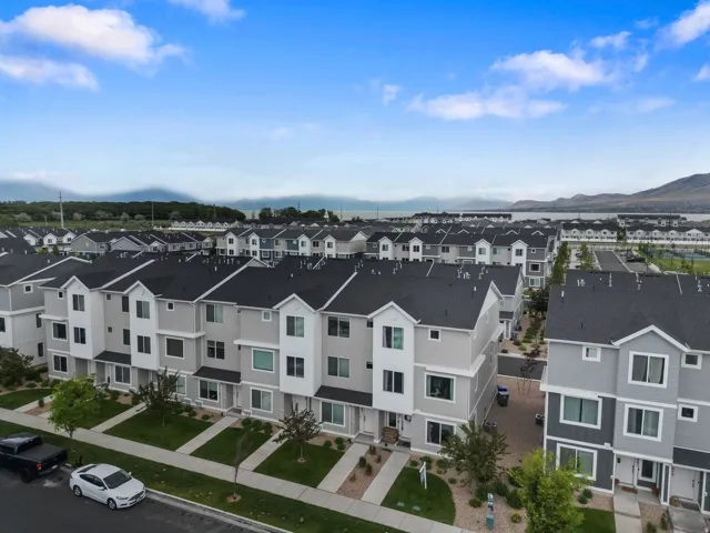 Contemporary townhome exteriors featuring light gray siding and dark gray roofing