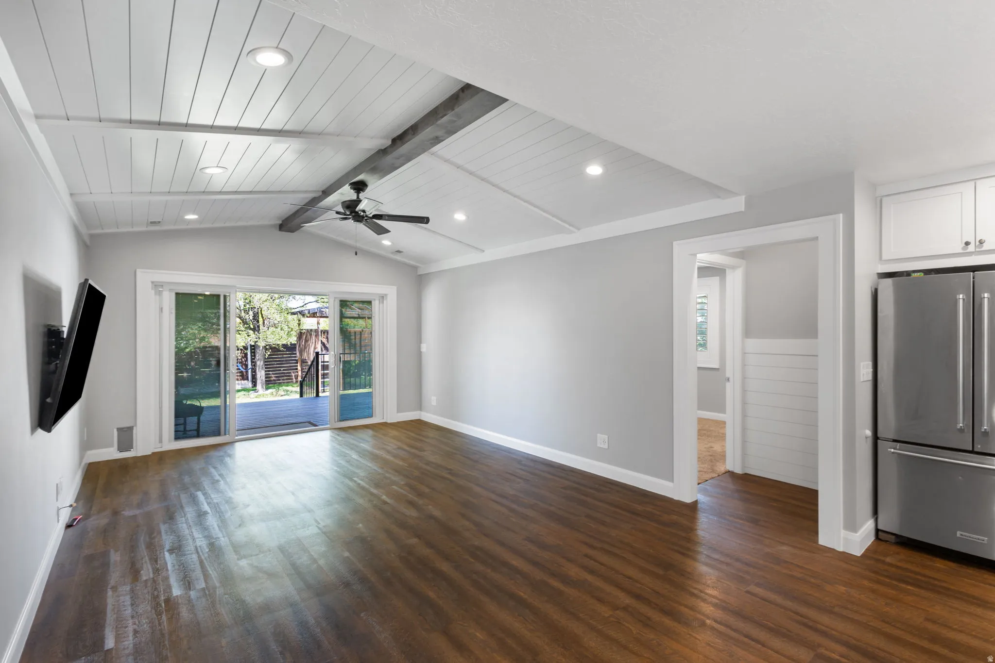 Vaulted ceiling with white plank finish and recessed lighting