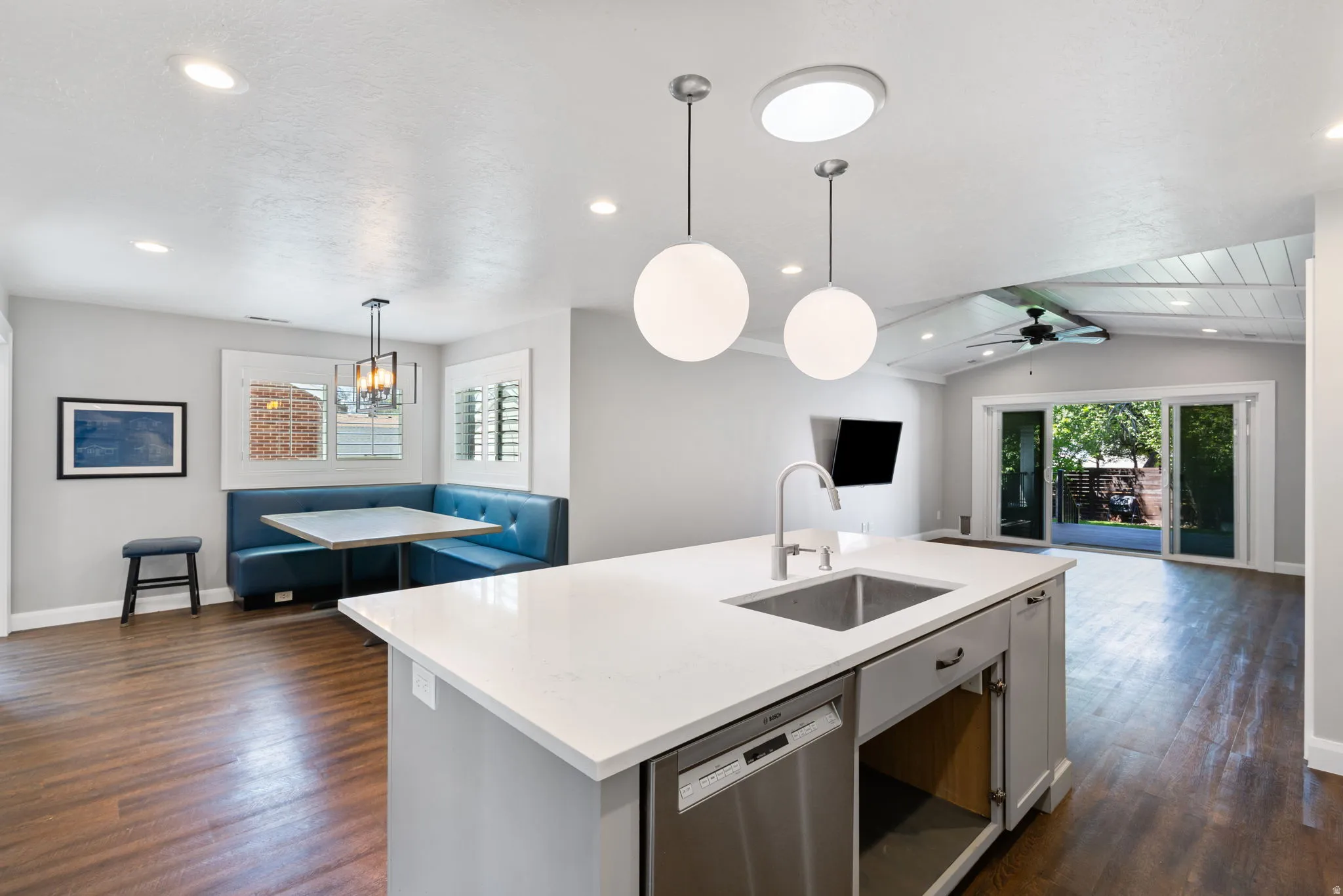 Kitchen island featuring a stainless steel sink and integrated dishwasher
