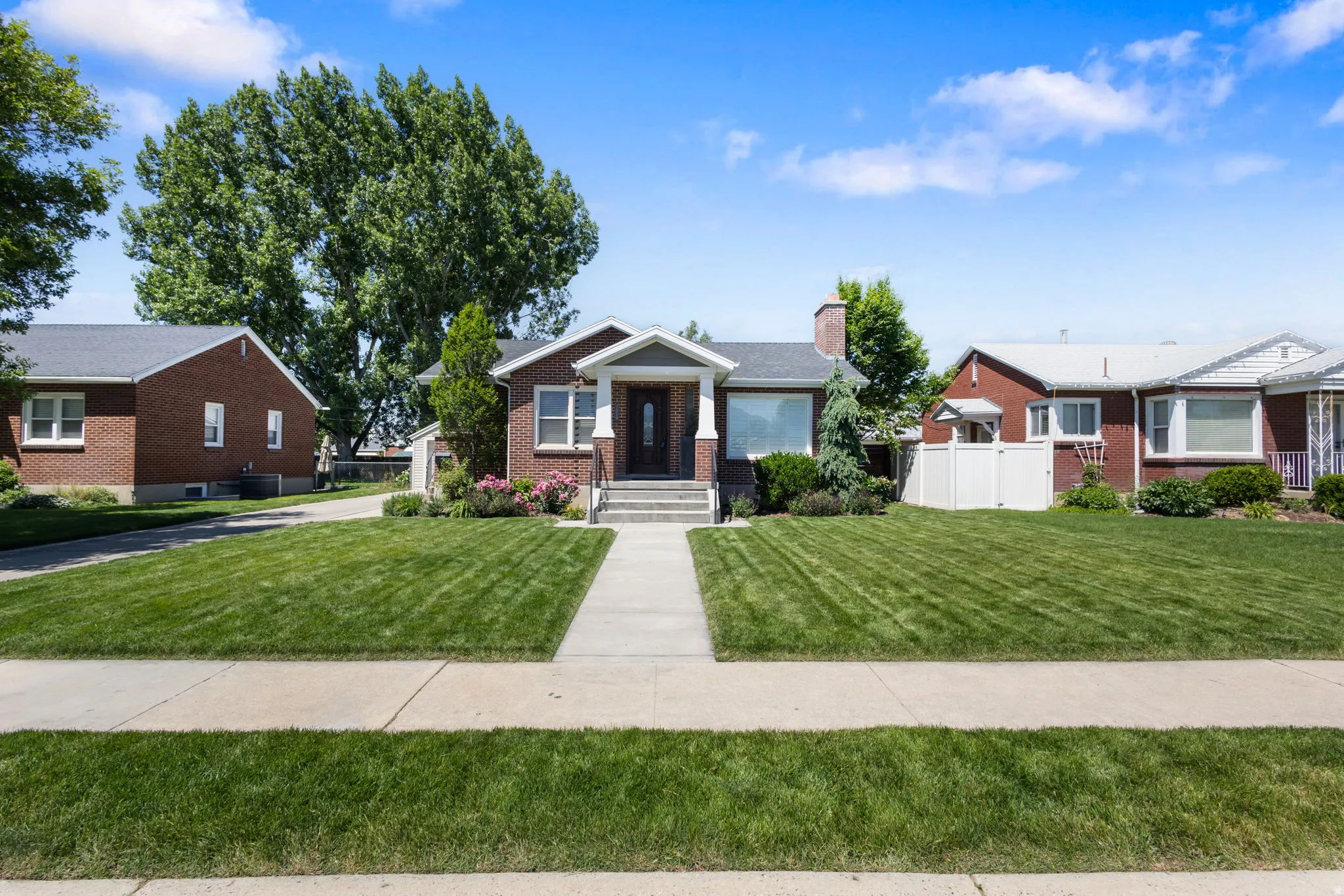 1950's character with large addition. Brick exterior featuring a covered porch entry, a bay window, and a gabled roofline