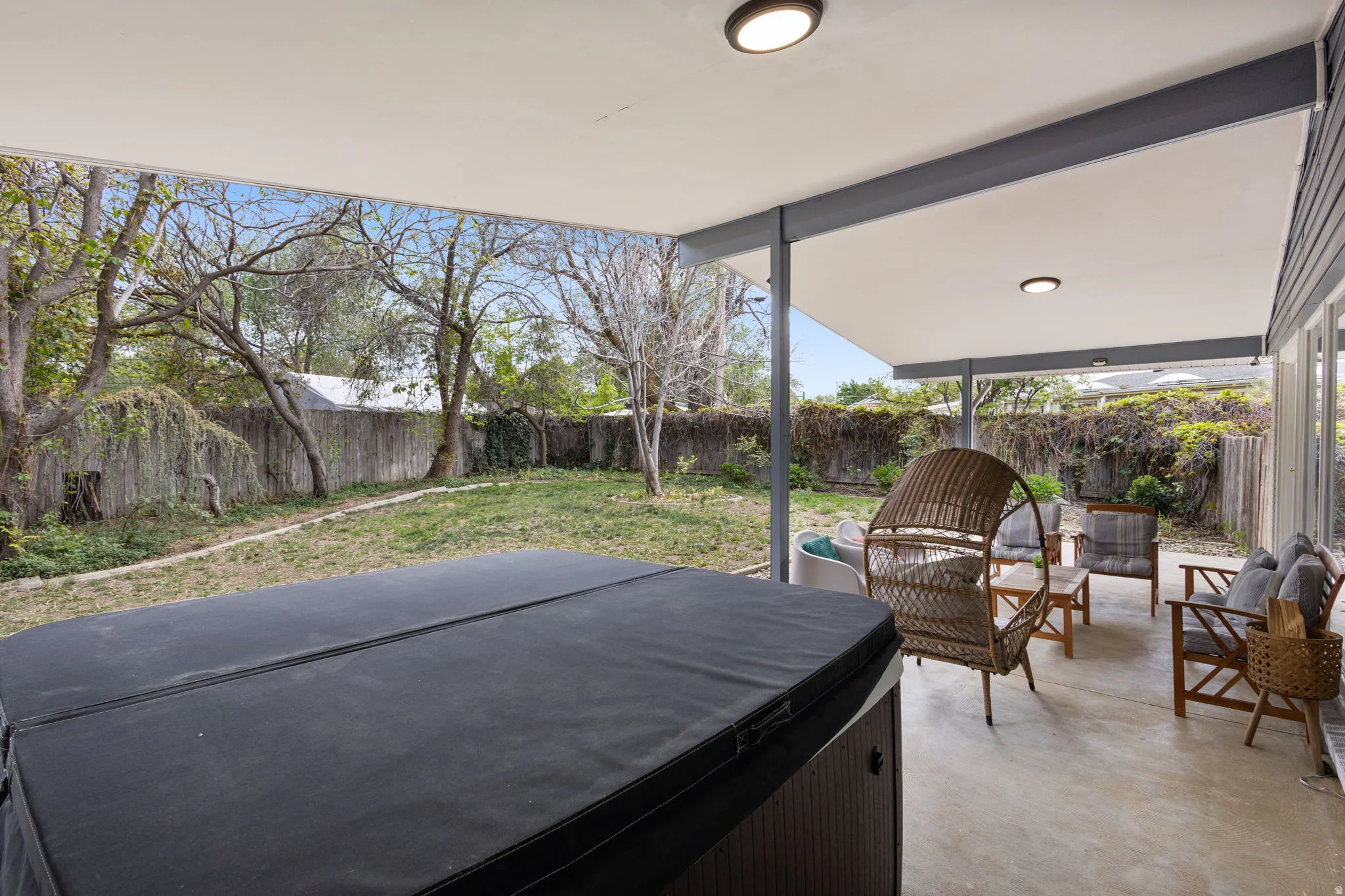 Expansive covered patio featuring recessed lighting, a built-in spa, and a concrete surface