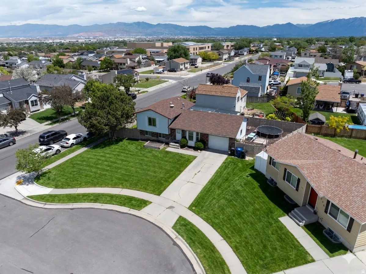 Ai enhanced Aerial perspective featuring suburban neighborhood with distant mountains