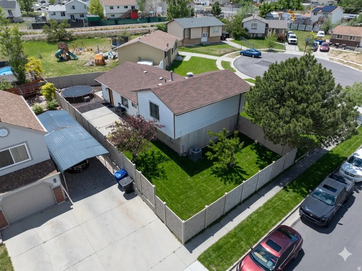 Ai enhanced Rear property with a fenced yard featuring lawn and mature trees