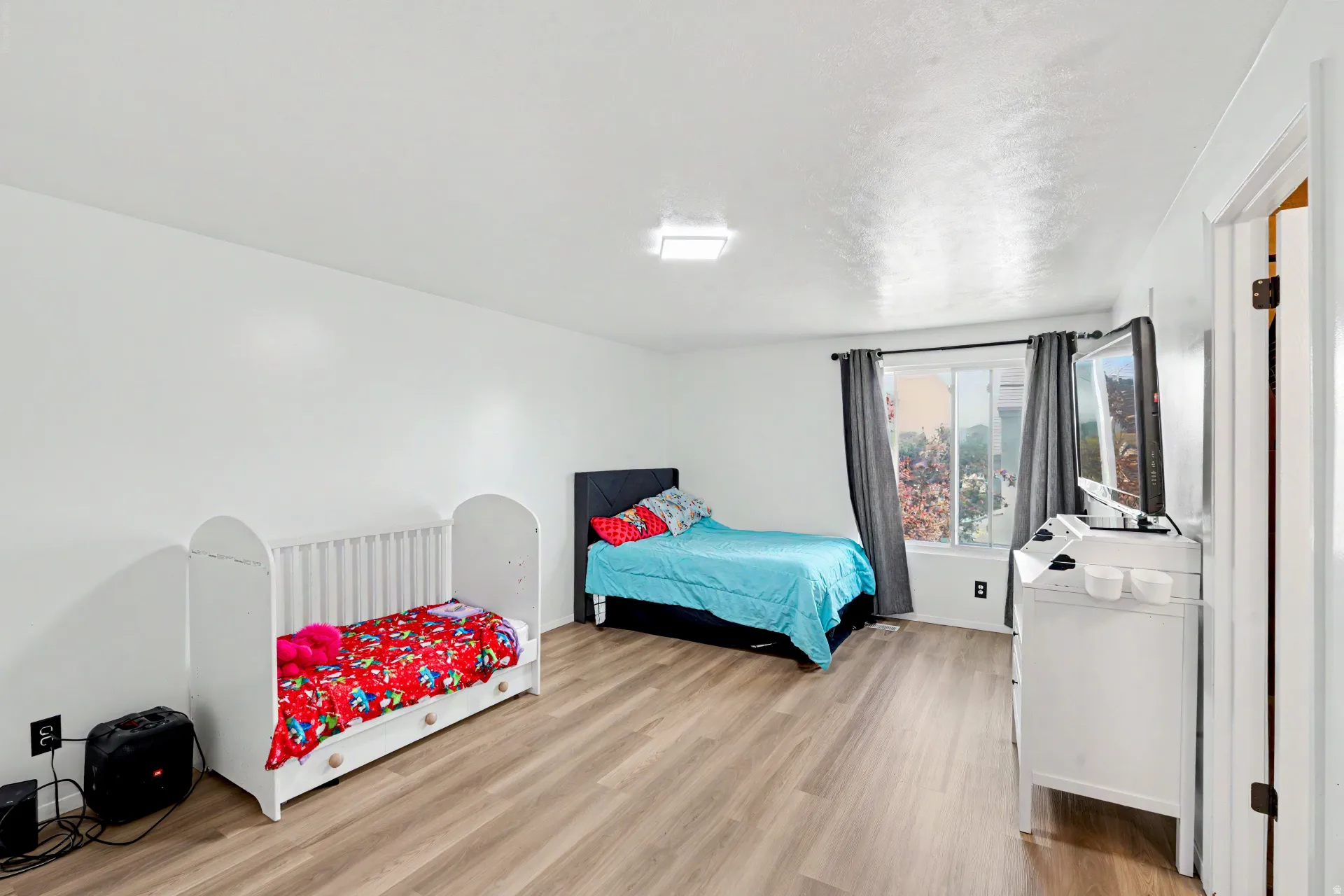 Primary Bedroom featuring wood-finish flooring and white walls