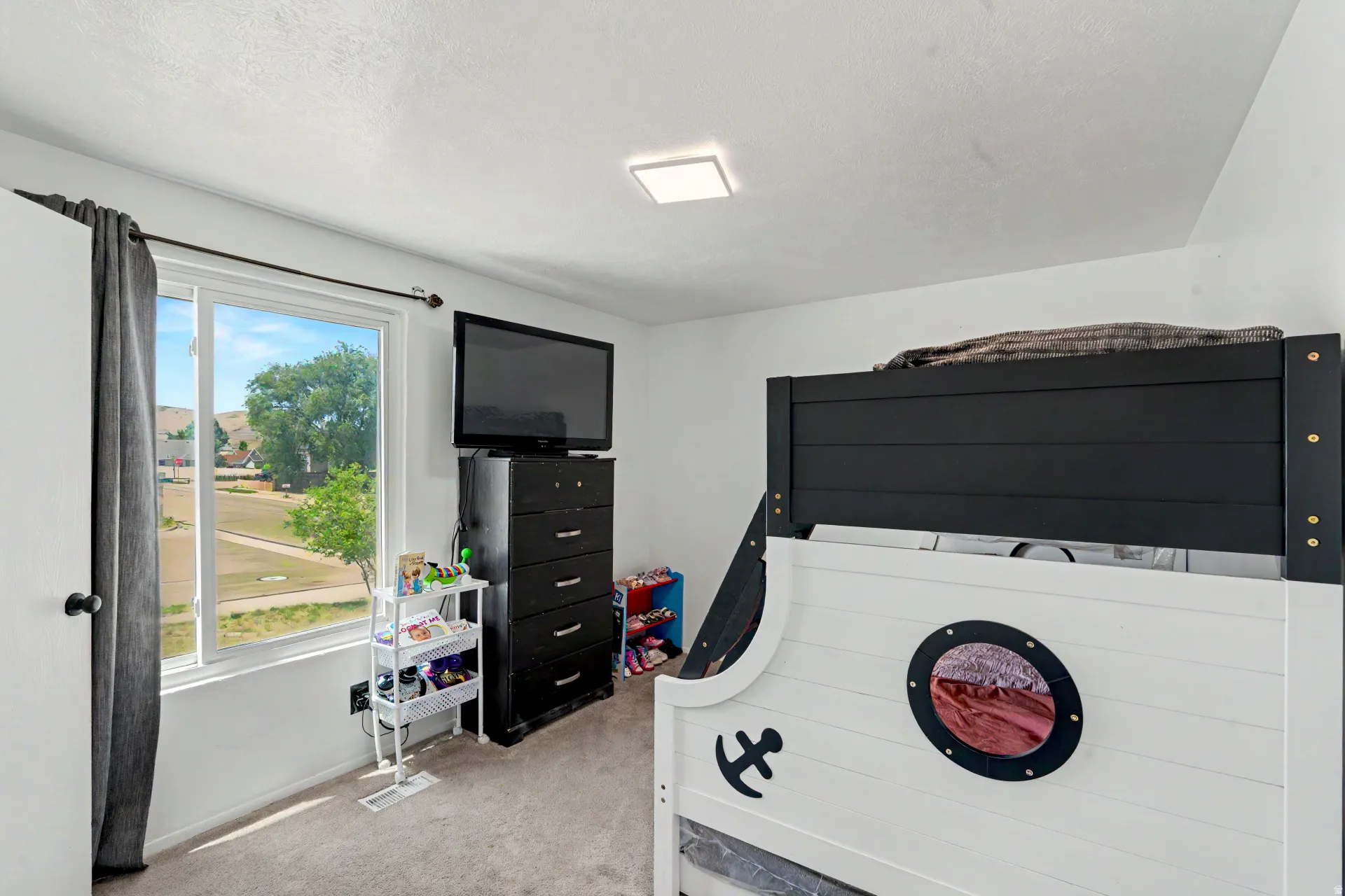 2nd room upstairs  with carpeted flooring, a rectangular window with white framing, and a ceiling-mounted flush light fixture