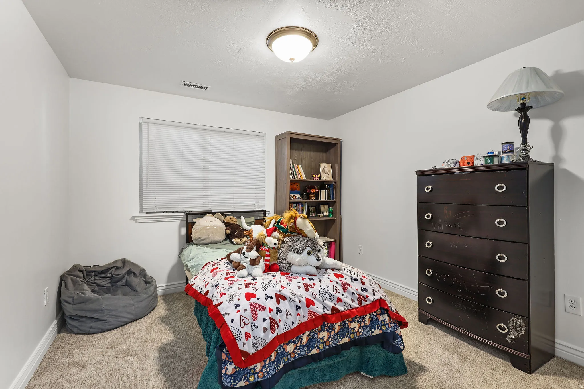 Bedroom featuring neutral carpeting and white walls