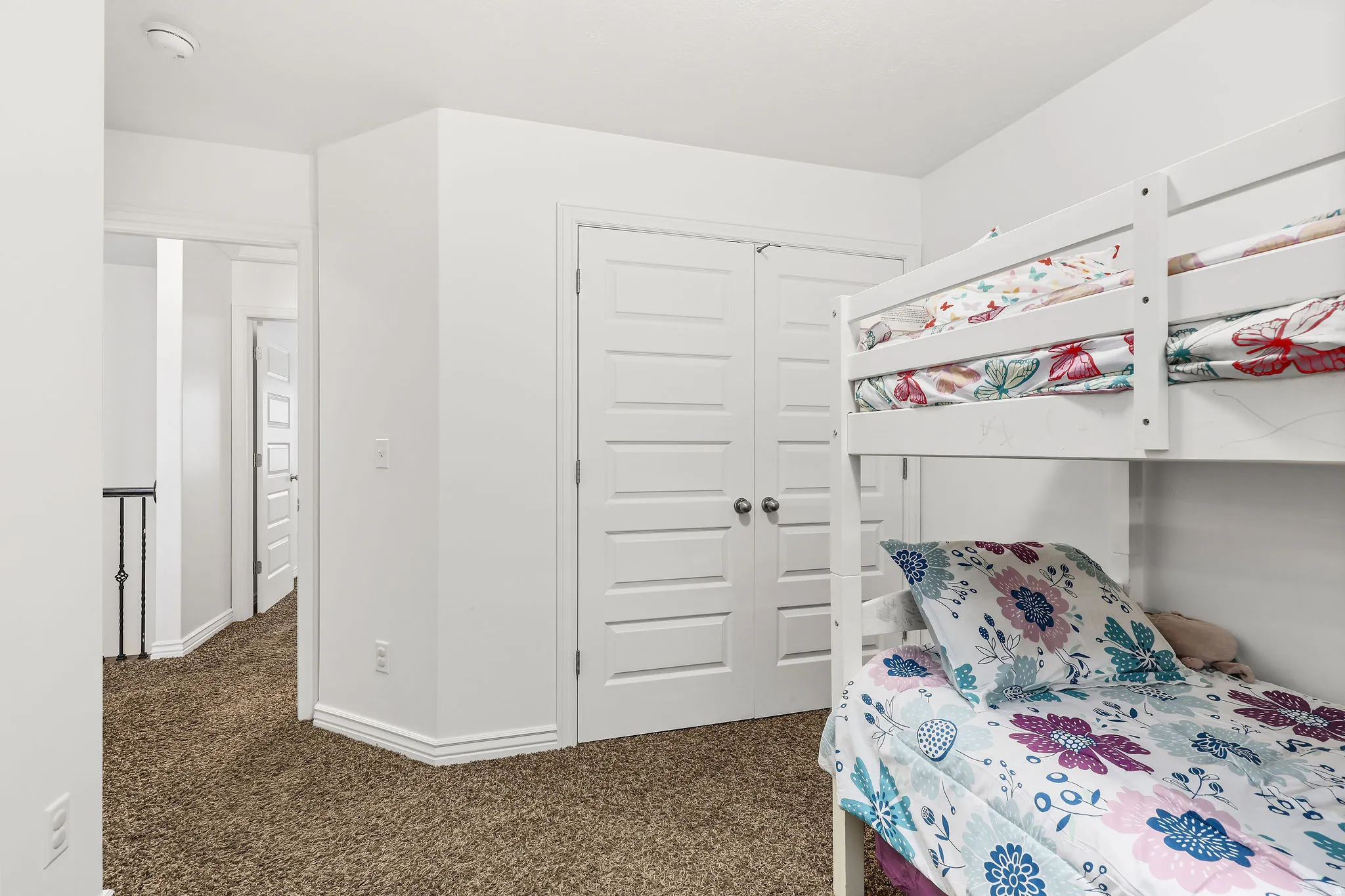 Room featuring plush carpet flooring, white painted walls, and white trim