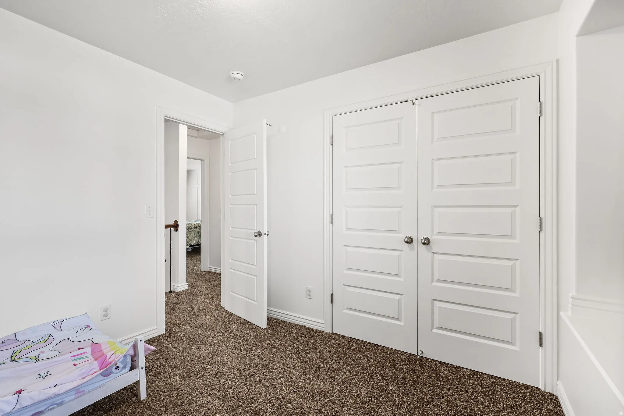 Room featuring neutral-toned carpet flooring and white walls