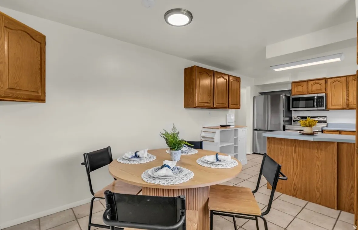 Kitchen featuring wood-finish cabinetry and tile flooring