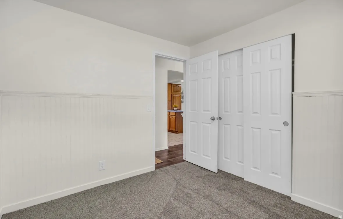Room featuring neutral wall paint and white beadboard wainscoting