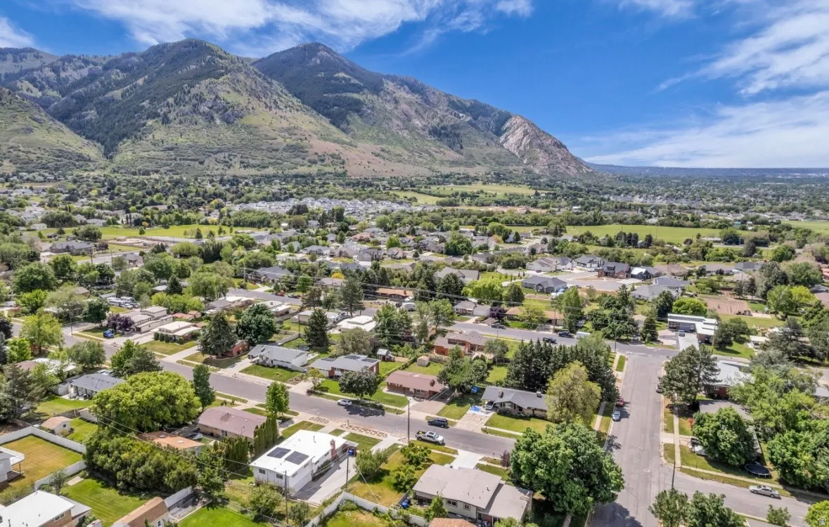 Aerial perspective showcasing a residential neighborhood with a prominent mountain backdrop