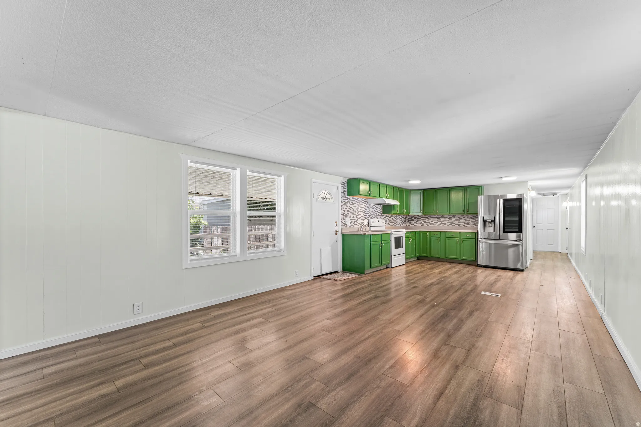 Open concept living area featuring wood-finish flooring