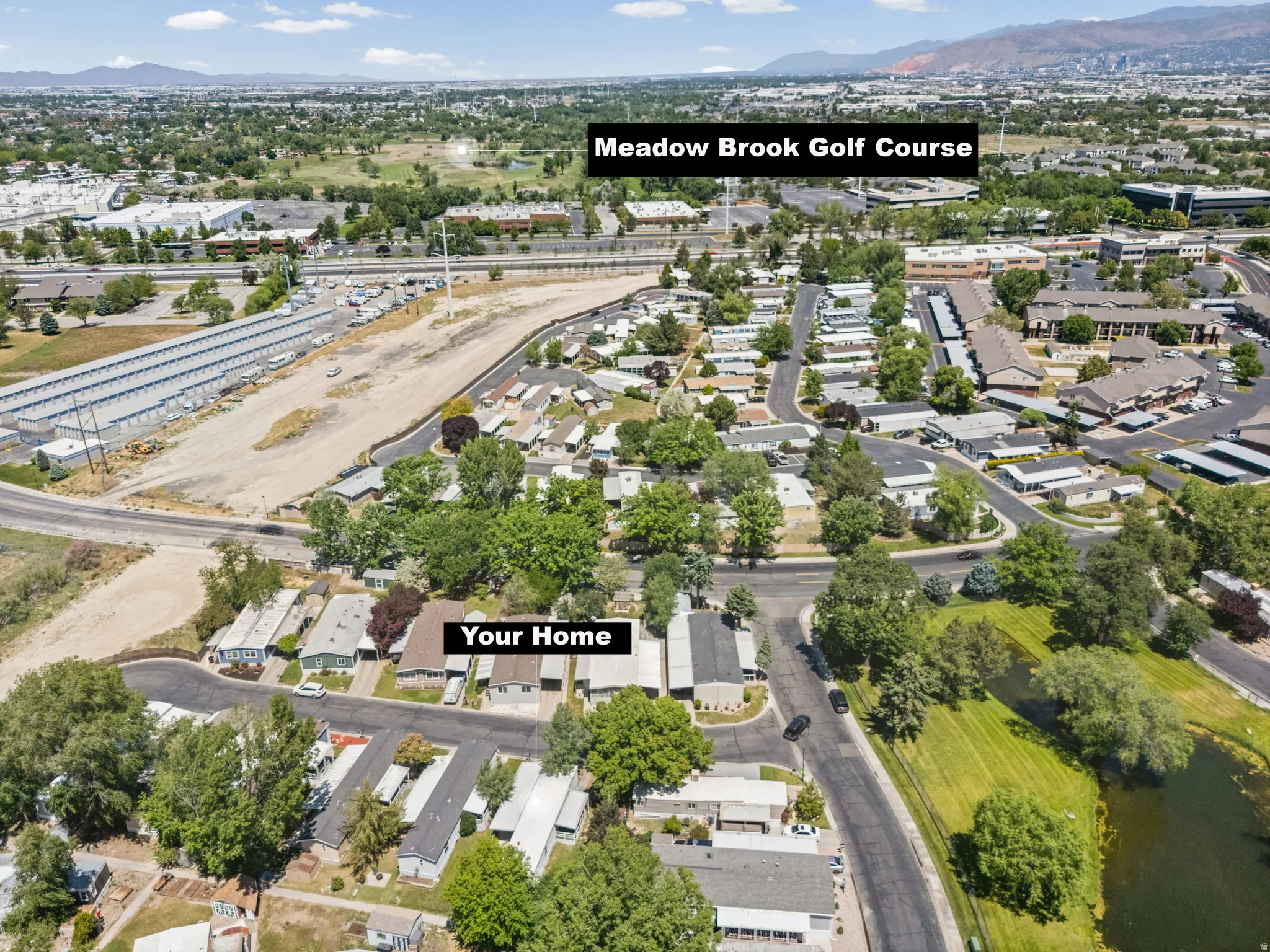 Aerial perspective featuring the surrounding neighborhood, residential properties, and a body of water