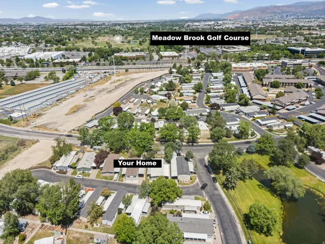 Aerial perspective featuring the surrounding neighborhood, residential properties, and a body of water