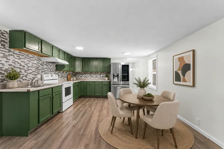 Kitchen featuring dark green cabinetry, white appliances, a mosaic tile backsplash, and wood-finish flooring
