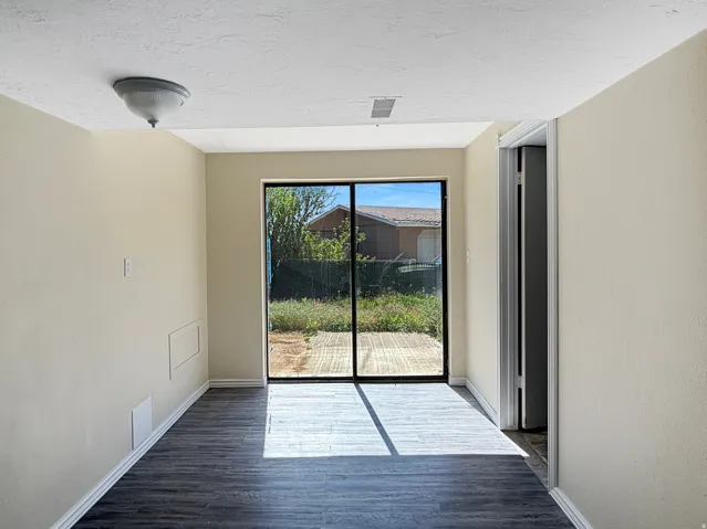 Sliding glass doors opening to an exterior wood-finish deck